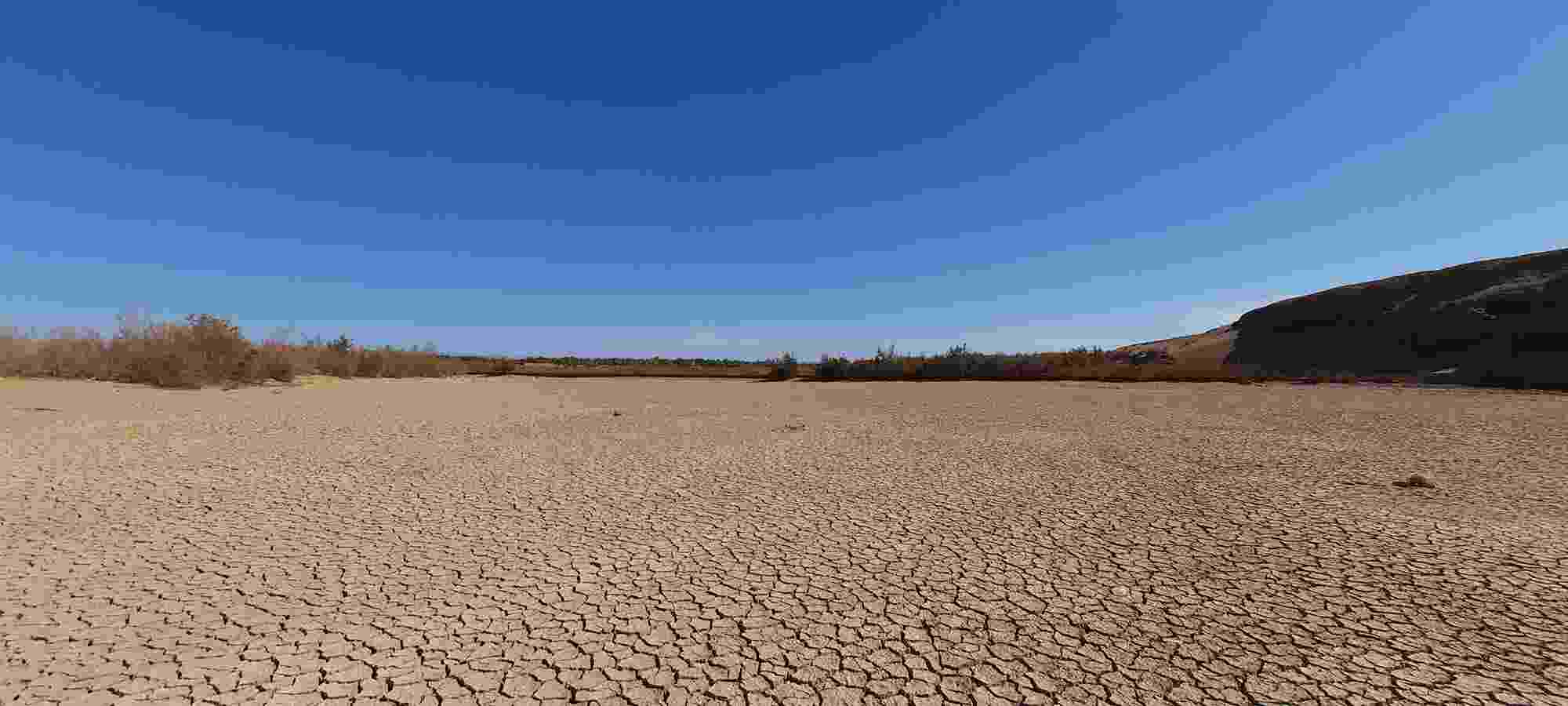 A dried-up dam in Morocco, now just parched and cracked earth